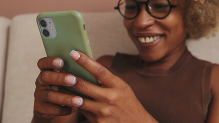 Fototapeta premium Happy Woman Smiling At Phone With Green Case