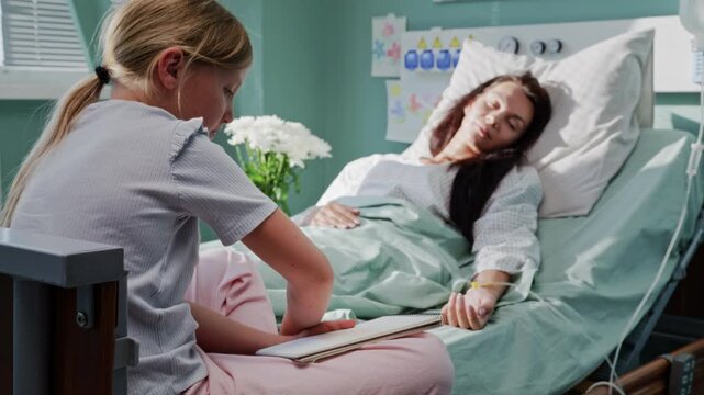 Girl draws cheerful picture while mother rests in hospital bed