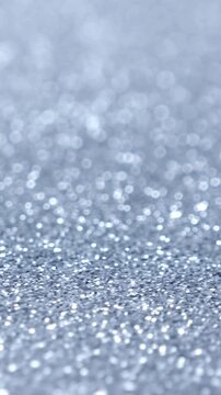 Shiny silver background. Rotate. Christmas celebration. Winter holidays. Vertical footage