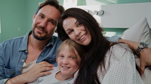 Family smiles together during supportive hospital recovery
