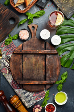 Stone black cooking background. Kitchen board with vegetables and spices. On a black stone background. Top view