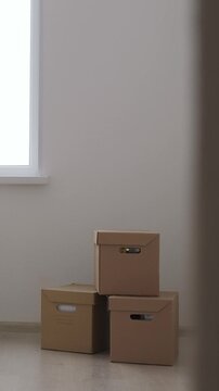 Cardboard boxes for moving at room interior movement or delivery concept. Vertical footage
