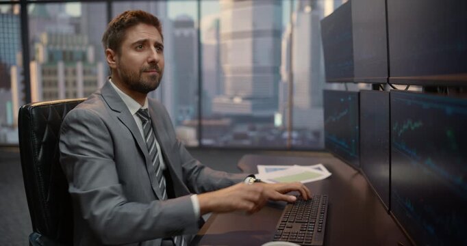 Successful Male Stockbroker Sips Coffee While Reviewing Stock Market Charts Across Multiple Monitors at His Desk, Evaluating Financial Reports and Investment Data for Capital Growth. Zoom out Portrait