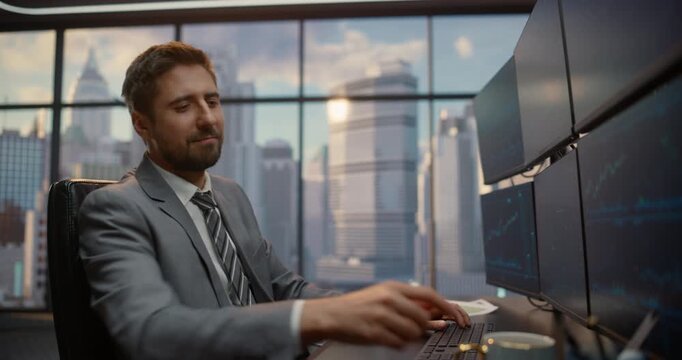 Portrait of Male Stockbroker Monitors Multiple Computer Screens of Market Data at His Desk, Tracking Equity Indices and Financial Trends to Drive Investment Strategy and Maximize Capital Growth.