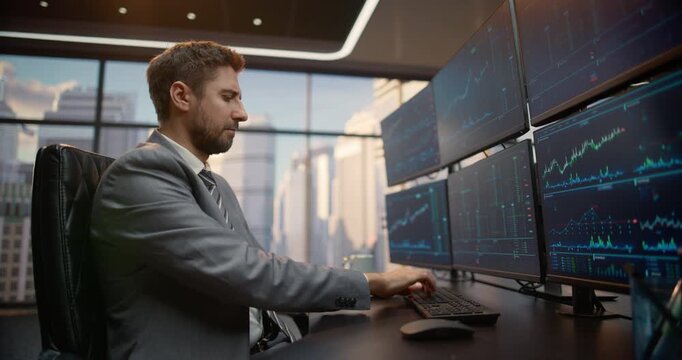 Portrait of Male Investment Analyst at Desk Reviews Stock Exchange Data on Multiple Computer Screens, Tracking Equity Trends, Ticker Feeds and Market Analytics to Optimize Portfolios, Grow Capital