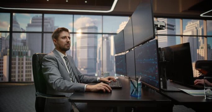 Portrait of Stockbroker at Desk Analyzes Stock Exchange Data Across Multiple Monitors, Studying Equity Charts, Ticker Feeds, Maximize Profit, Capital Growth. Asset Management Company. Zoom out