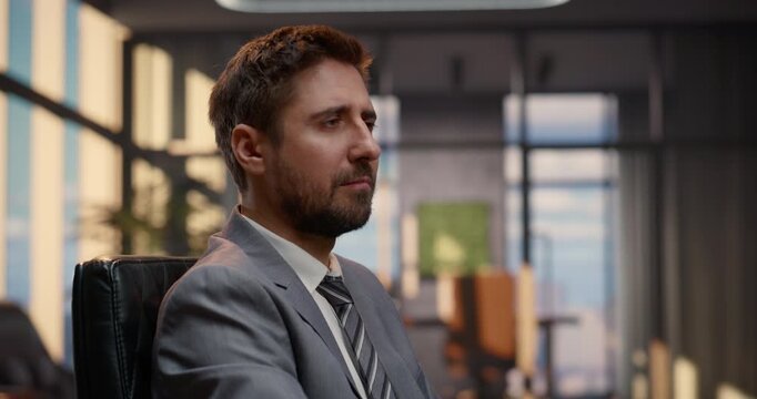 Thoughtful Businessman at a Desk Monitors Stock Exchange Data on a Wall of Computer Screens, Evaluating Equity Charts, Ticker Feeds and Financial Analytics to Plan Investment Strategy, Capital Growth.