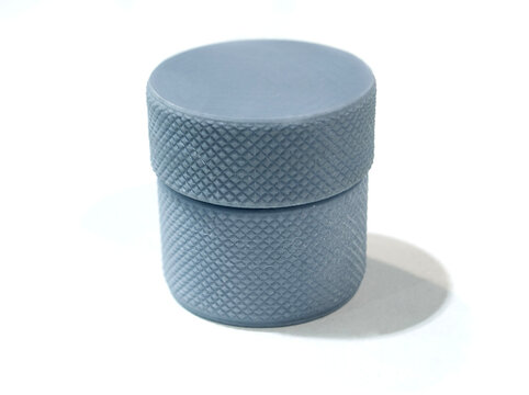 3D printed model knurled container using photopolymer resin on 3D printer. Object printed on 3D printer from liquid resin isolated on white background. SLA technology. Stereolithography 3D printing