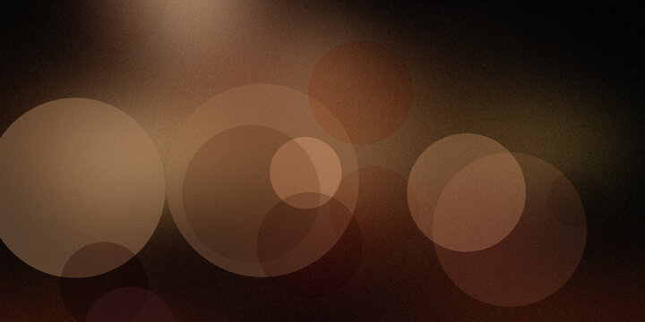 Abstract dark background with warm bokeh light effect brown circles festive wallpaper design.
