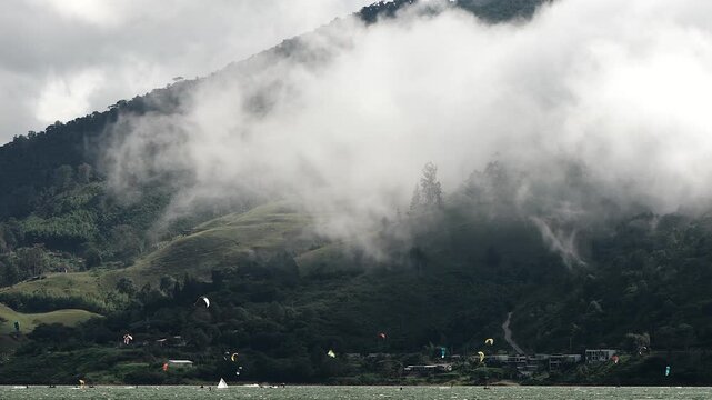 dramatic clouds covering mountains over lake calima landscape