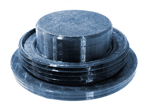 3D printed part from black plastic on 3D printer. Object printed on 3D printer from molten plastic isolated on white background. FDM Fused Deposition Modeling technology. Additive modern manufacturing