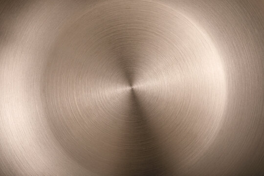 Abstract brushed metal surface with circular brushed lines.