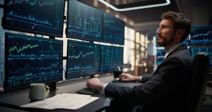 Side Profile Portrait of Stockbroker at Desk Looking at Computer Screens Showing Stock Exchange Data, Equity Charts, Investment Analytics, Asset Management, Financial Graphs to Track Market Trends