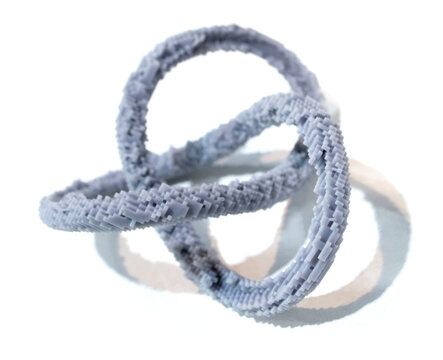 3D printed model of infinity loop. Voxel art style. Model created using photopolymer resin. Object printed on 3D printer from liquid resin isolated on white background SLA technology Stereolithography