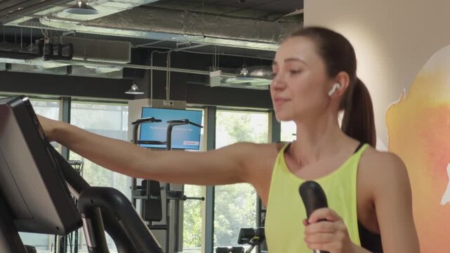 Woman exercising on elliptical trainer for cardio fitness