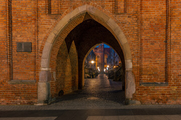 View through the Women's Gate towards Women's Alley in Gdańsk at night, Poland. © Bernhard