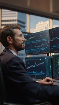 Vertical Screen. Portrait of Male Trader Working at Desk, Reviewing Stock Market Charts and Financial Data for Smart Investment Decisions, Portfolio Management and Capital Growth.