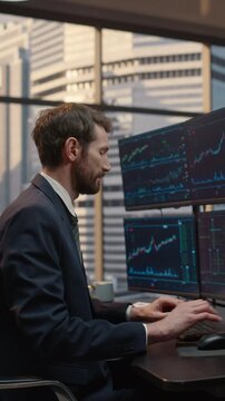 Vertical Screen. Male Stockbroker Analyzes Market Data and Financial Charts on Computer at Desk, Monitoring Stock Exchange Trends for Investment Strategy and Capital Growth.