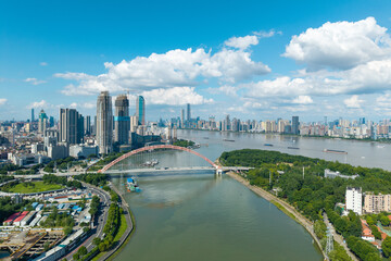 Fototapeta premium A high angle aerial view of the cityscape and a large bridge crossing the Yangtze River in Wuhan China on a clear sunny summer day