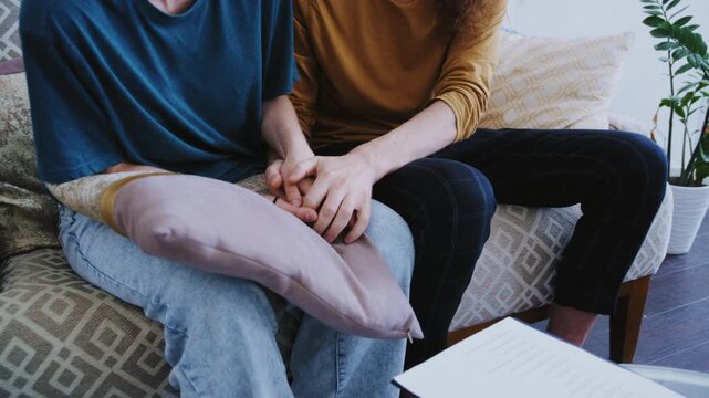 Two adults participate in a family consultation, expressing thoughts through gestures and attentive listening 