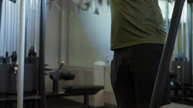 Man performing cable crossover exercise in a modern gym for fitness and strength