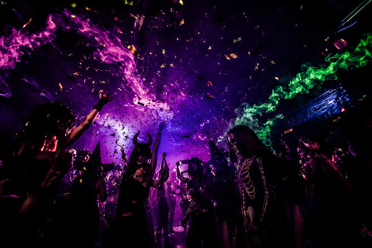 Energetic Halloween Party with Costumed Crowd Dancing Under Confetti and Neon Lights in a Dark Club Setting