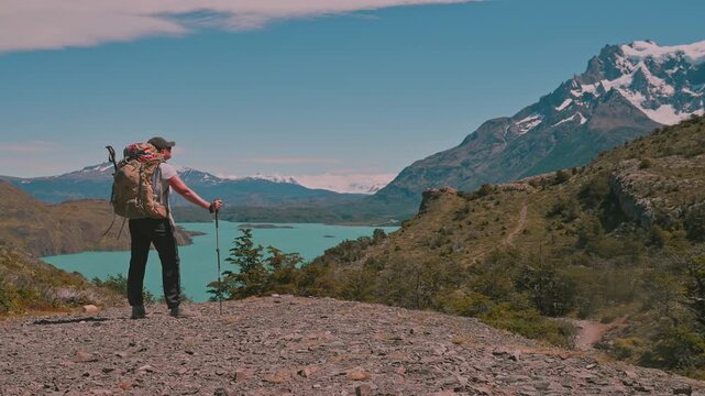 Backpacking hiker enjoying amazing view from Torres del Paine national park on the W Trek, Patagonia, Chile