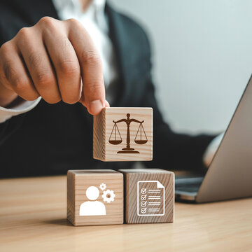 Hand holding wooden blocks with justice, profile, and document icons