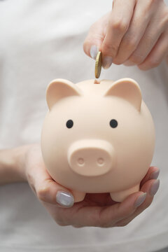 Hand holding smiling piggy bank with increasing  for financial saving and investment growth concept.