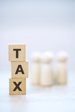 Tax Concept. Wooden Blocks with different heights of money heaps. Personal Income, people Corporate, Financial Research, payment.