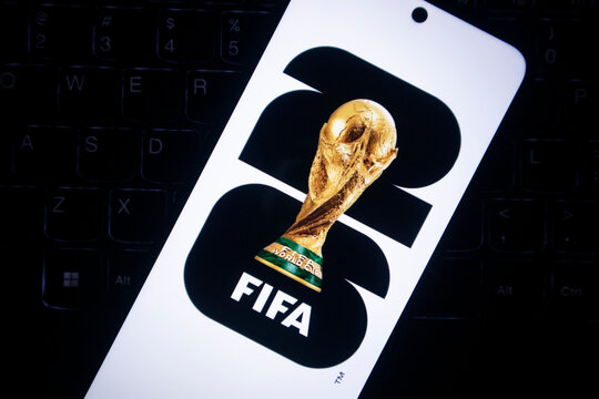 Pacitan, Indonesia - July 14, 2026 : Close-up of the FIFA World Cup 2026 emblem displayed on a smartphone screen over a keyboard.