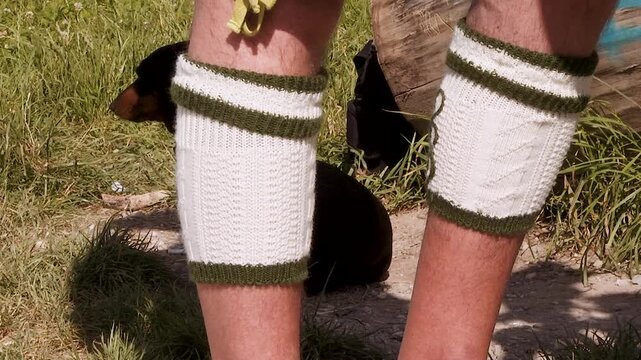 Dackel mit Edelwei&szlig;halsband neben traditioneller bayerischer Tracht
