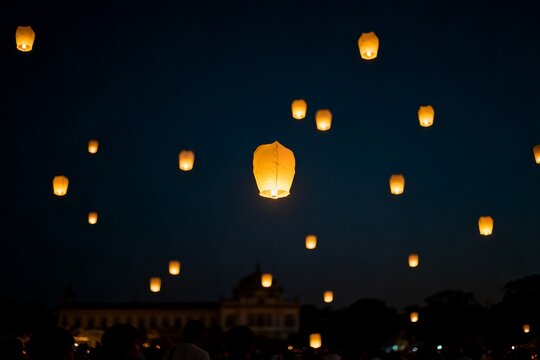 Sky lanterns floating in night sky