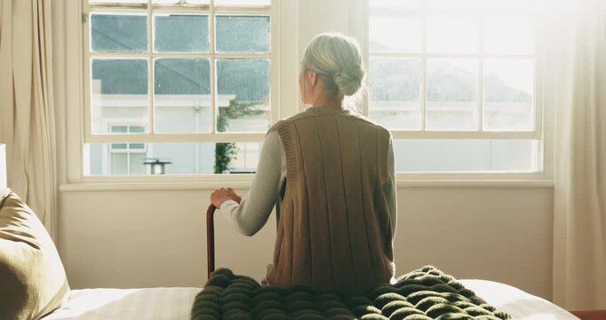 Thinking, back or old woman at window with walking stick, daydream or calm mindset in retirement. Reflection, flare and elderly person with disability, flashback or peaceful perspective in home.