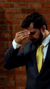 Eavesdropping with focused expression, Indian Asian young businessman or CEO in formal corporate attire with beard overhears secret conversation by spying while standing in cozy office