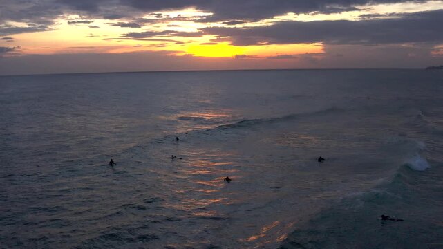 Surfers Riding Waves at Sunset on Polhena Beach, Sri Lanka