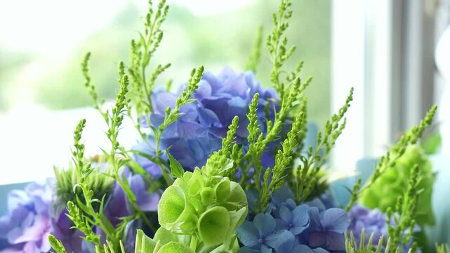 incredible cute romantic bouquet of flowers in green and blue tones. large bouquet of flowers, summer atmosphere. Green, blue, purple. Hydrangea ,Molucella Irish bells, Solidago , Echinacea