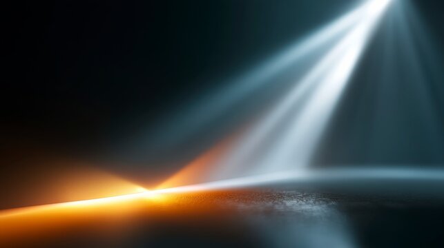 A dramatic close-up of a dark surface lit by contrasting warm orange and cool blue spotlights, creating an abstract, futuristic atmosphere.