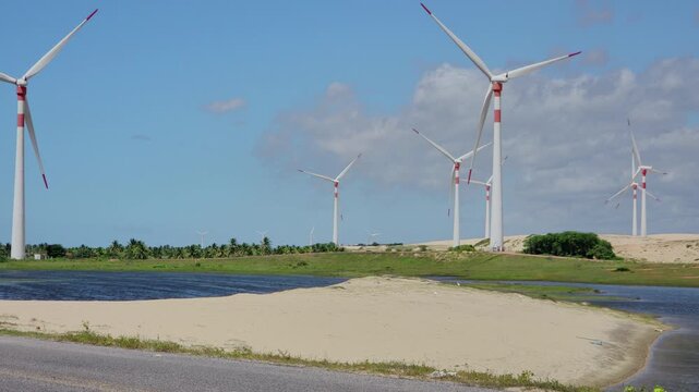 Massive Wind Turbines on Coastal Dunes Against Dramatic Cloudy Sky. Munda&uacute;, Brazil