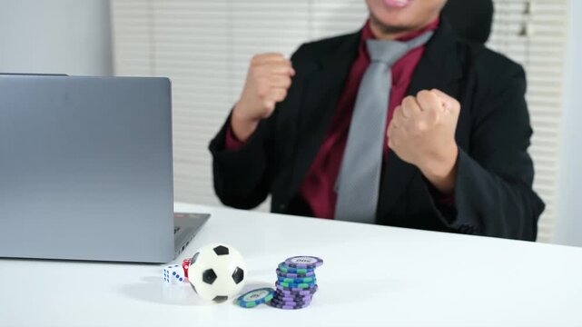 An expression of victory in soccer gambling. A clenched fist, an expression of success in front of a laptop. Luck. Good fortune.
