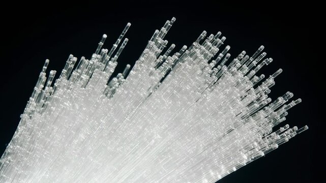 Transparent glass fiber strands arranged in a dynamic formation, showcasing their intricate structure and light reflection against a dark background