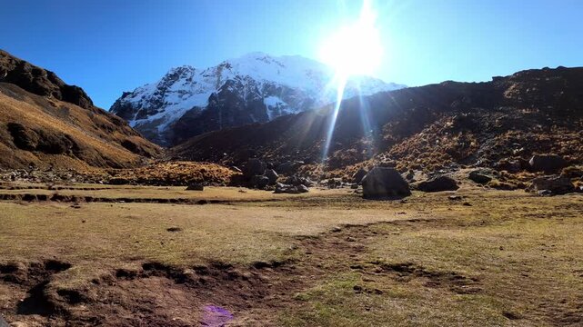 Sun shines over majestic snow-covered mountain peak in peruvian andes