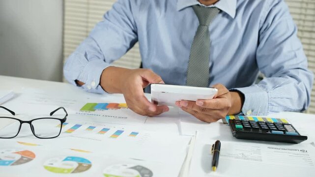 Person scrolling on smartphone while reviewing financial information, Business records. Online tax filing, Digital documentation, Workflow management, Mobile productivity remote work concept
