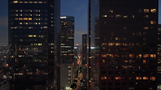 Towering skyscrapers and modern glass buildings in Los Angeles downtown illuminating streets at twilight. Cityscape featuring urban metropolis in California, America. 02,02,2026, Los Angeles, USA, 