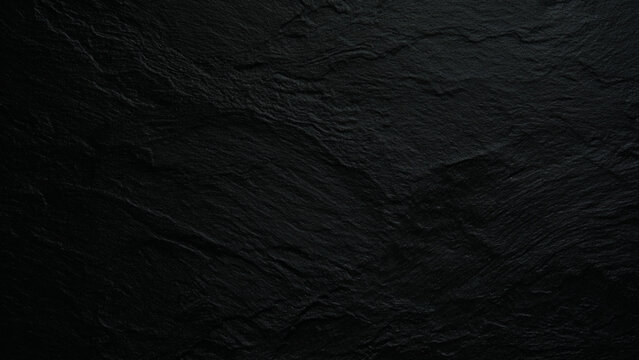 Black slate stone texture background with rough natural surface and cracks