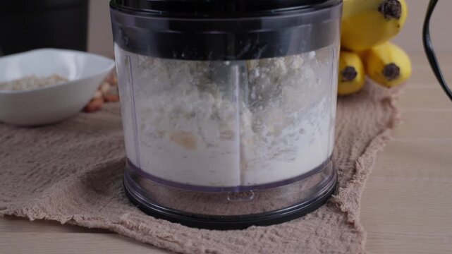 Preparing healthy breakfast in food chopper with cottage cheese and banana. Nutritious homemade meal and healthy lifestyle concept