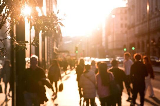 Blur of people walking against of sunset at Piccadilly street, London 
