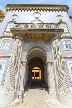 Exquisite Moorish-Manueline portal of the Pena Palace in Sintra, Portugal, featuring intricately carved twisted rope columns, a horseshoe arch with muqarnas-style ornamentation .