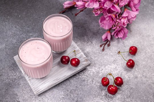 Cherry smoothie yogurt drink with fresh cherries and flowers