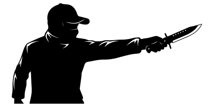 A man wearing a cap holds a knife in his right hand threateningly.